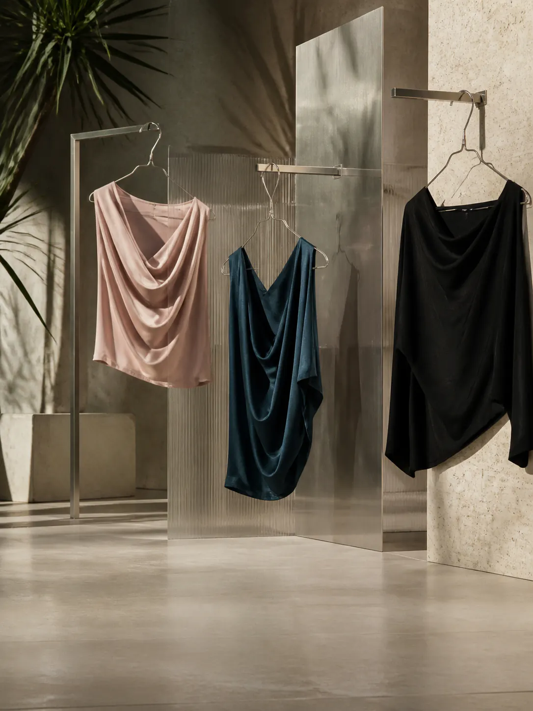 Editorial study of draped tops in a warm, sunlit studio